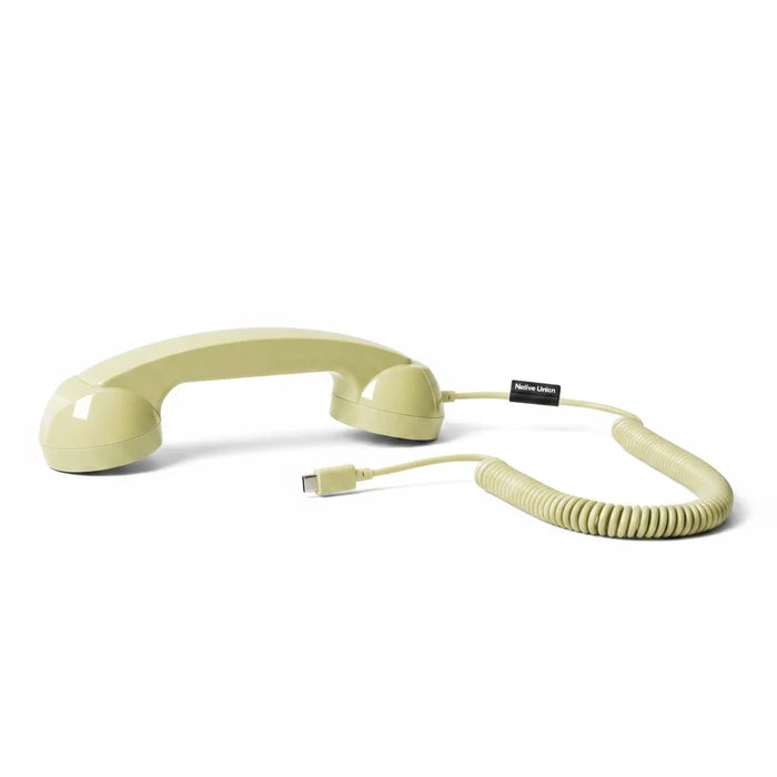 A retro-style lemon yellow rotary telephone handset with a coiled orange cord and a USB-C connector, shown on a clean white background.
