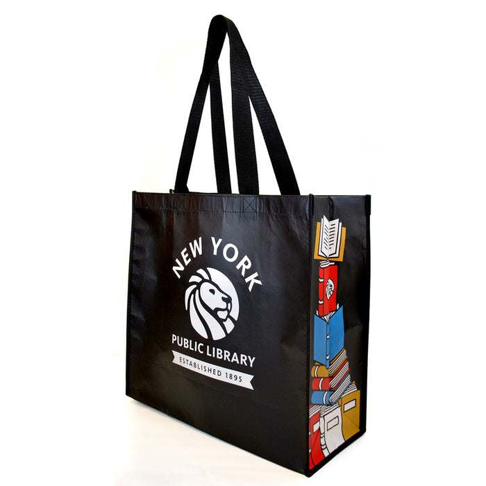 A black reusable tote bag with the New York Public Library logo and a colorful book stack design on the gussets.