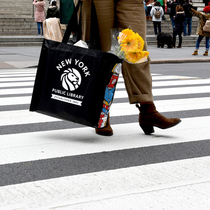 Someone carrying the tote with groceries and flowers.