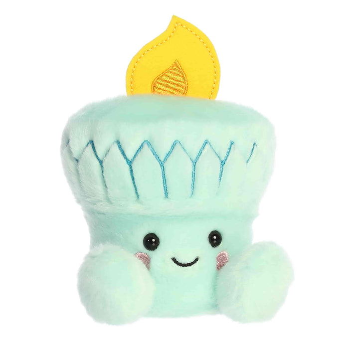 A small, cute teal plush toy shaped like the Statue of Liberty's torch with a smiling face and a yellow felt flame