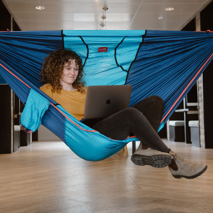 Woman sitting in ROVR while working on laptop indoors