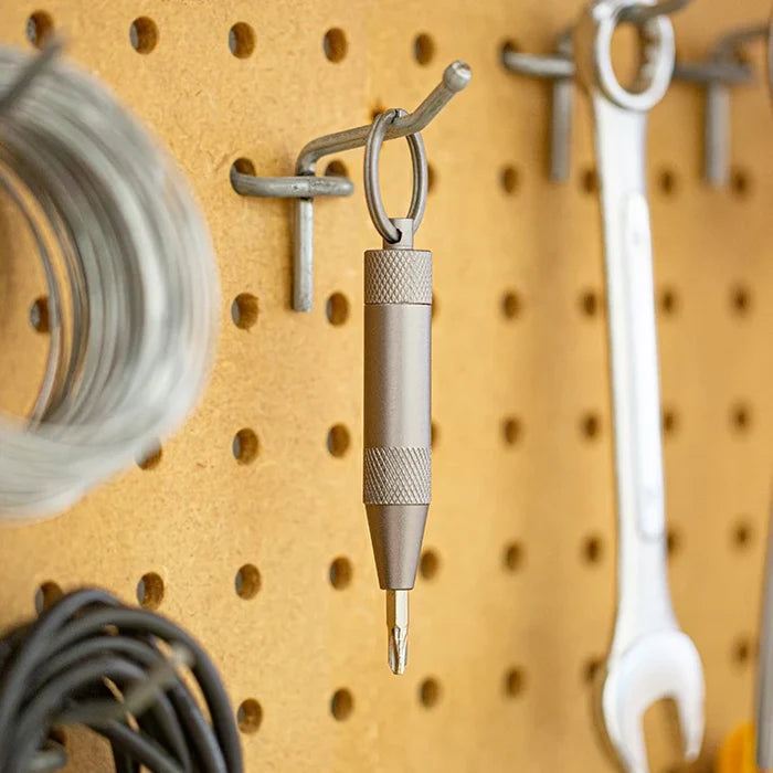 Mini tool hanging on a pegboard with various items