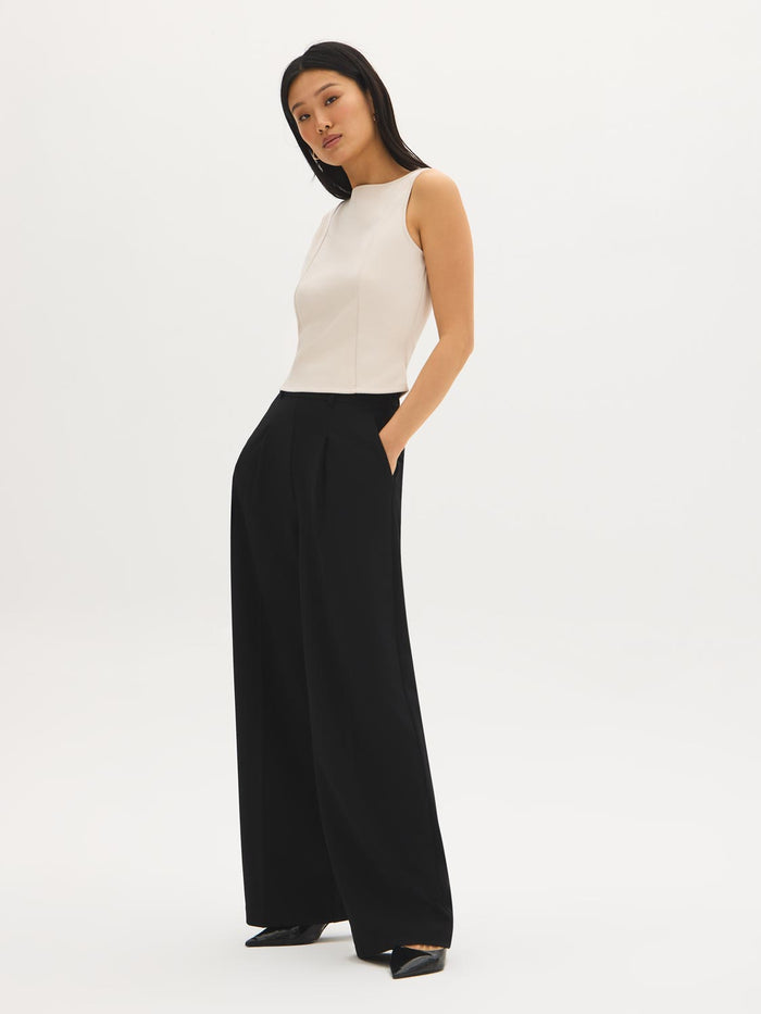Sleeveless faux suede shell top with boat neckline by Suzy.