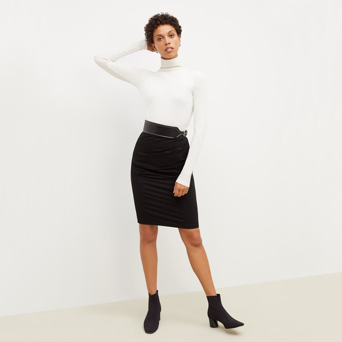 Front image of a woman standing wearing the soho skirt in black | Lead