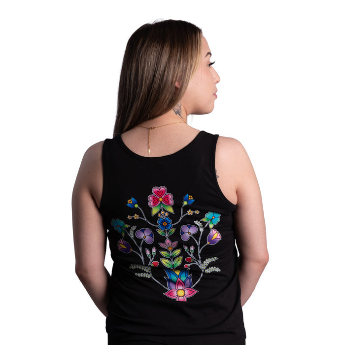 Woman wearing a black tank top with colorful floral design on the back against a white background