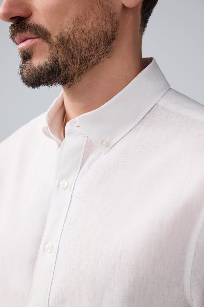 Detailed view of a man wearing Tech Linen Button Up in Bright White
