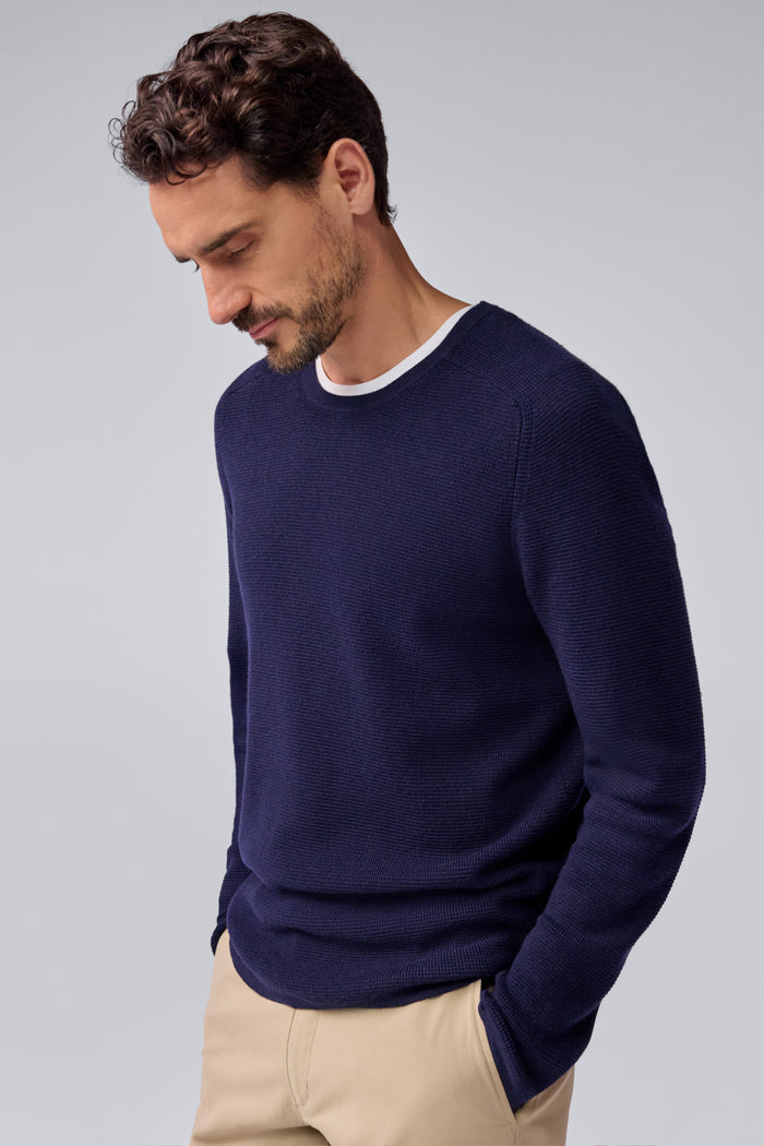 Side view of a man wearing Tech Merino Waffle Crew Neck Sweater in Total Eclipse