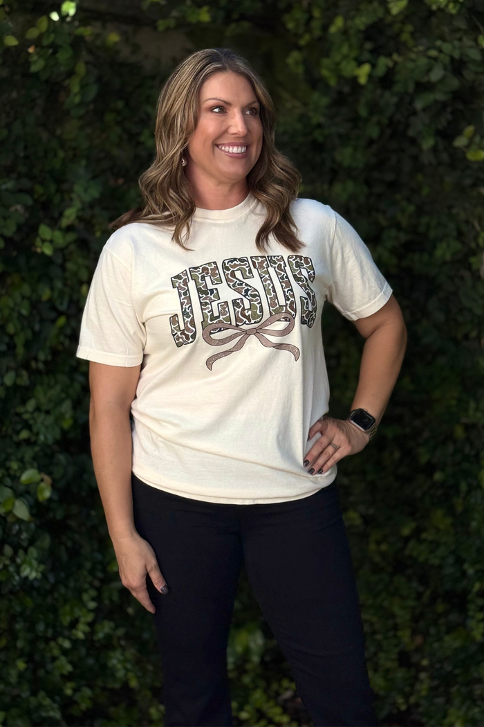 Close-up of camo print Jesus design on ivory t-shirt