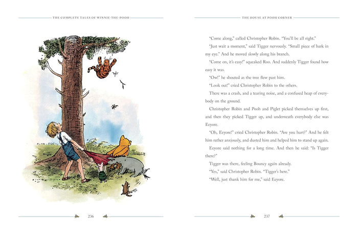 An open book spread from "The House at Pooh Corner" displaying a classic color illustration of Christopher Robin pulling a blanket while Tigger tumbles down from a large pine tree.
