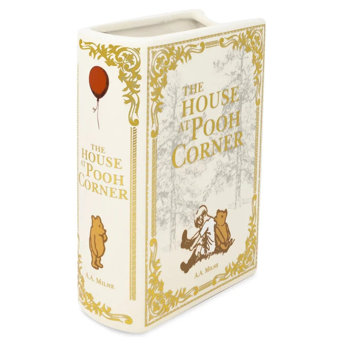 Book-shaped container with 'The House at Pooh Corner' design on a white background