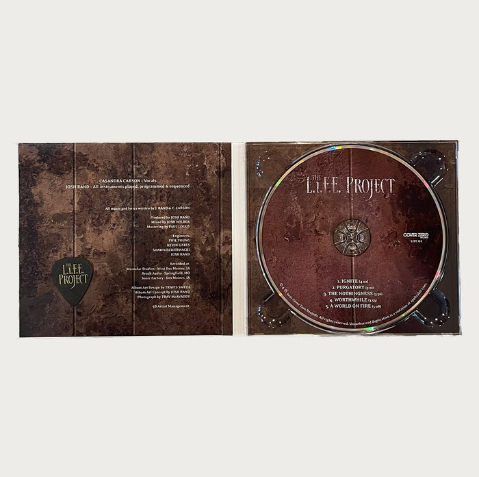 Open CD case of The L.I.F.E. Project from The L.I.F.E. Project, displaying the CD on the right and the tracklist with songs like Purgatory and A World On Fire, plus credits on the left, set against a rustic brown vintage background.