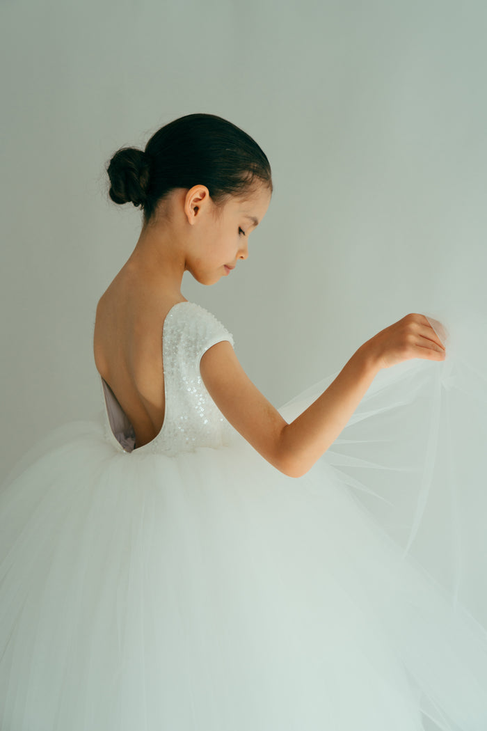 White dress with puffy tulle skirt and sequin backless top