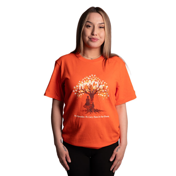 Person wearing an orange t-shirt with a tree design on a white background