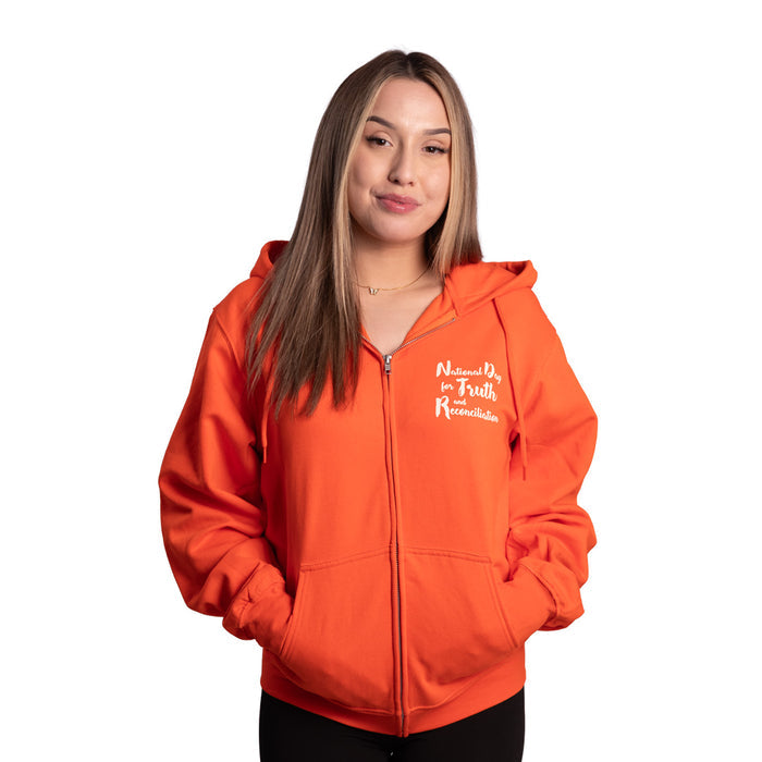 Person wearing an orange hoodie with text on a white background