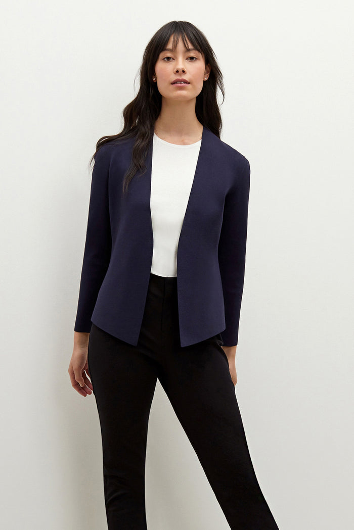 Front image of a woman standing wearing the Woolf jardigan in navy | Exclude
