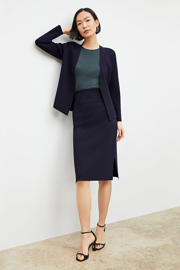 Front image of a woman standing wearing the Woolf jardigan in navy | Exclude | Grid Hover